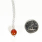 Dainty Carnelian pendant Choker Necklace beside a dime