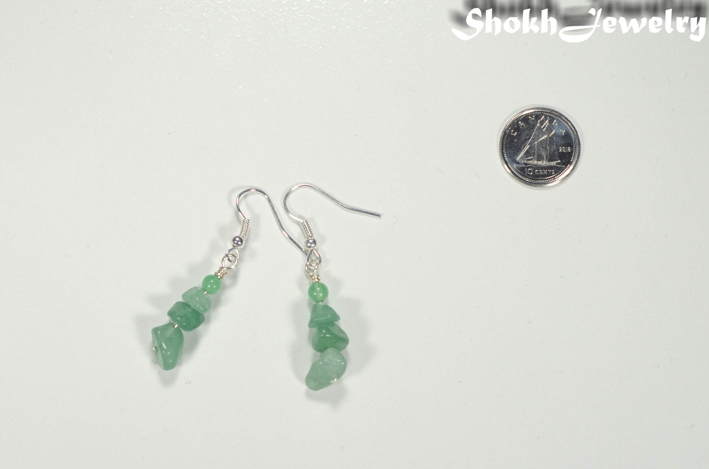 Natural Green Aventurine Crystal Chip Earrings beside a dime