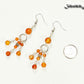 Statement Carnelian Crystal Chandelier Earrings beside a dime.